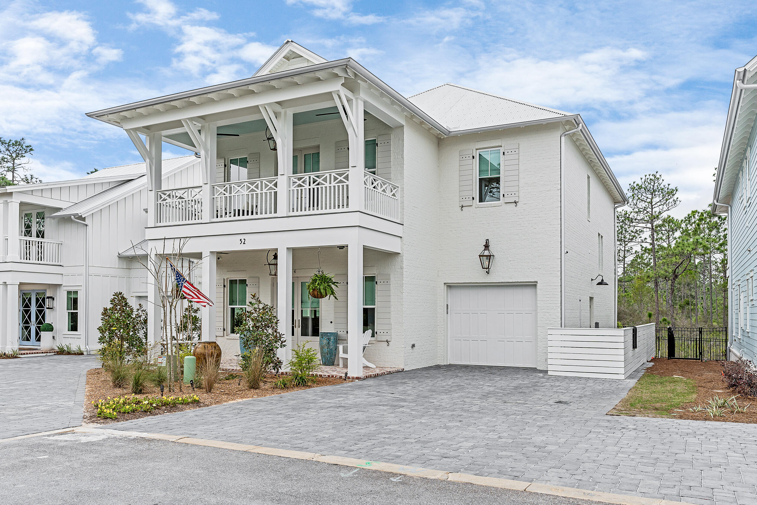 52 White Cottage Cove Santa Rosa Beach, FL 32459 - Photo 1 of 1 a view of a white house with large windows and plants