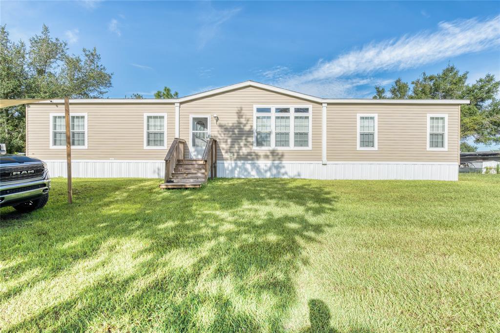 274 Northeast 106th Street Okeechobee, FL 34972 - Photo 1 of 43 front view of a house with a yard