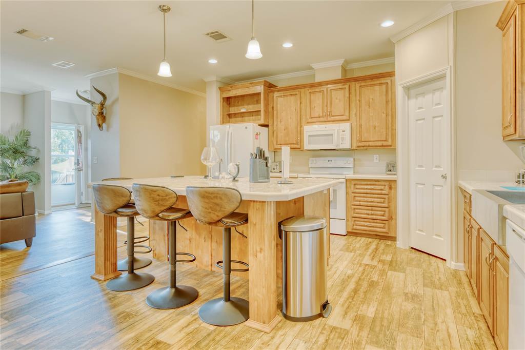 274 Northeast 106th Street Okeechobee, FL 34972 - Photo 11 of 43 a kitchen with stainless steel appliances kitchen island granite countertop a table chairs and a refrigerator