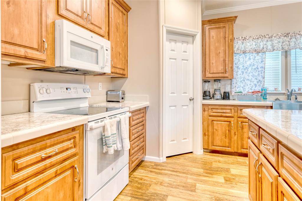 274 Northeast 106th Street Okeechobee, FL 34972 - Photo 13 of 43 a kitchen with stainless steel appliances granite countertop a sink and a stove next to a window