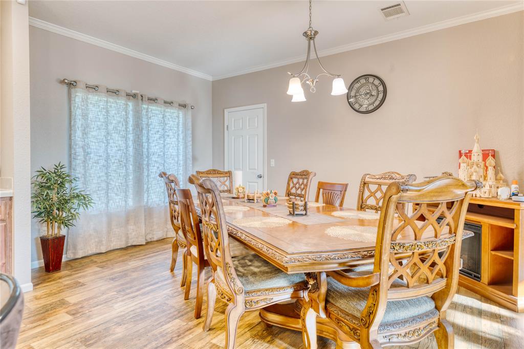 274 Northeast 106th Street Okeechobee, FL 34972 - Photo 14 of 43 a view of a dining room with furniture and wooden floor