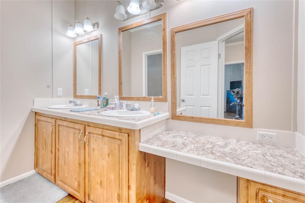 274 Northeast 106th Street Okeechobee, FL 34972 - Photo 15 of 43 a bathroom with a granite countertop sink and a mirror