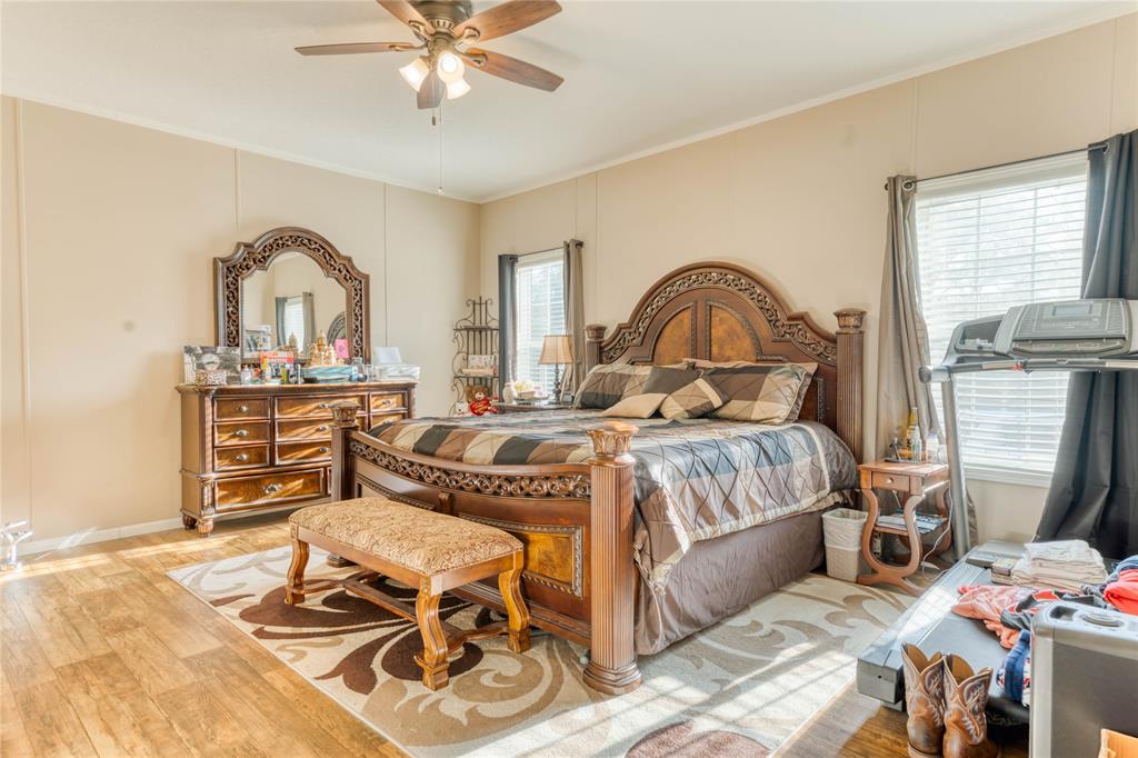 274 Northeast 106th Street Okeechobee, FL 34972 - Photo 19 of 43 a bedroom with a bed and a dresser with exposed radiator