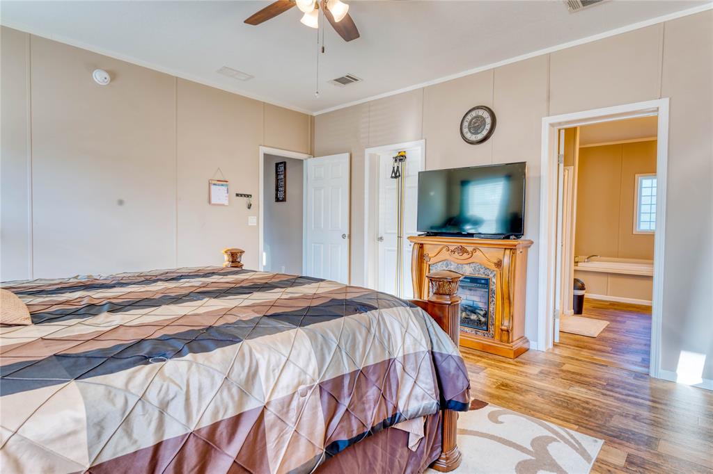 274 Northeast 106th Street Okeechobee, FL 34972 - Photo 20 of 43 a bedroom with a bed and a flat screen tv