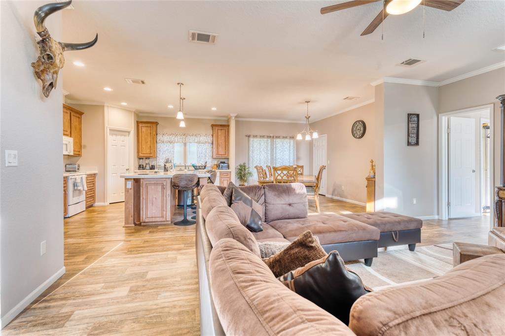274 Northeast 106th Street Okeechobee, FL 34972 - Photo 2 of 43 a living room with furniture kitchen view and a chandelier