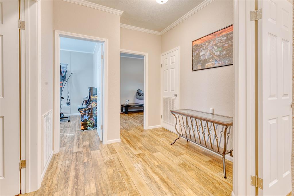 274 Northeast 106th Street Okeechobee, FL 34972 - Photo 25 of 43 a view of a hallway with wooden floor and a bedroom