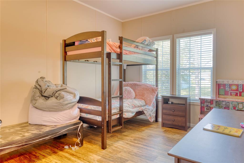 274 Northeast 106th Street Okeechobee, FL 34972 - Photo 29 of 43 a bedroom with furniture and a wooden floor