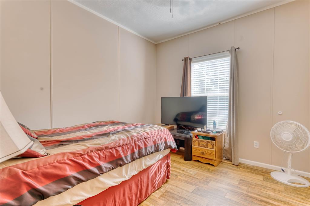 274 Northeast 106th Street Okeechobee, FL 34972 - Photo 33 of 43 a bedroom with a bed and flat screen tv