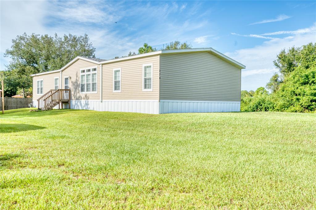 274 Northeast 106th Street Okeechobee, FL 34972 - Photo 38 of 43 a view of a house with a yard and garage