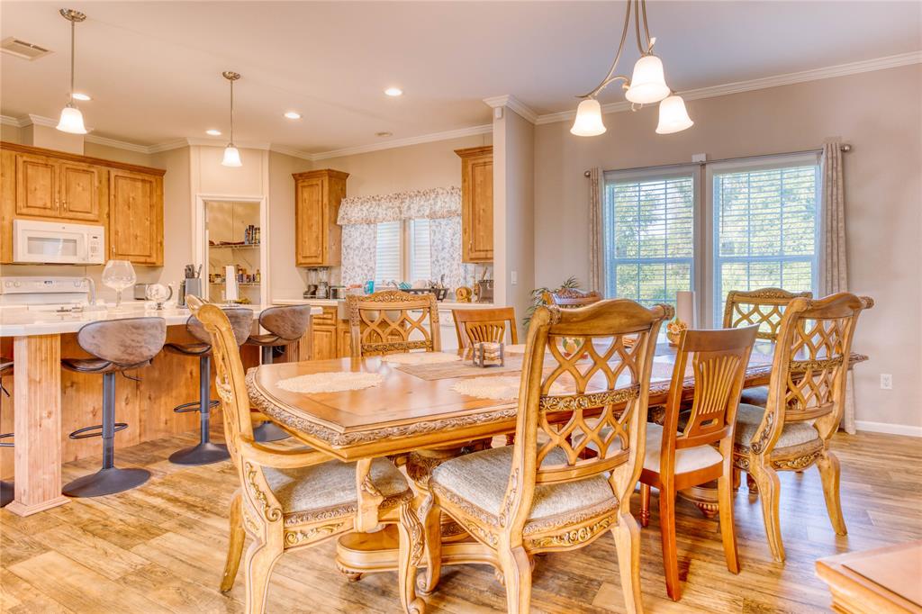 274 Northeast 106th Street Okeechobee, FL 34972 - Photo 6 of 43 a view of a dining room with furniture and chandelier