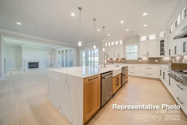 a large kitchen with a large counter top appliances and cabinets
