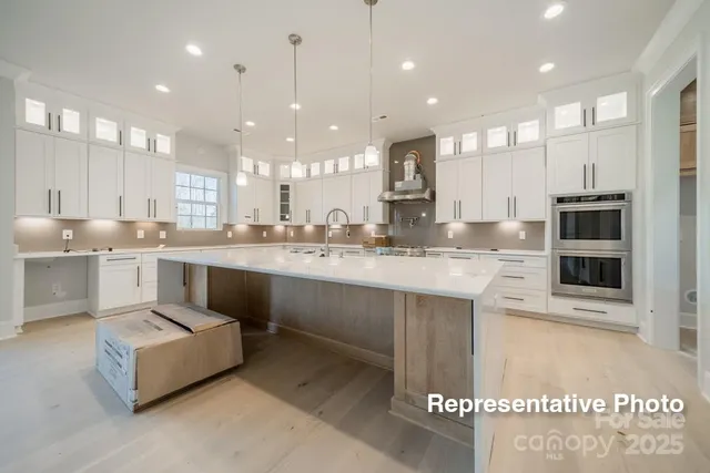 a kitchen with stainless steel appliances white cabinets and a sink