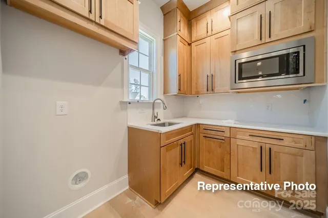 a kitchen with stainless steel appliances granite countertop a sink and cabinets