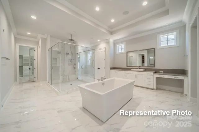 a large bathroom with a shower a sink and a large mirror