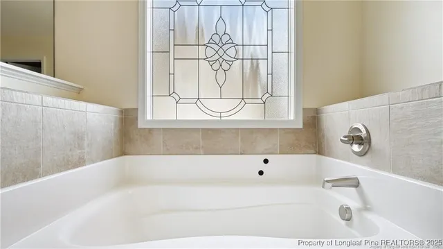 a white bath tub sitting next to a white sink