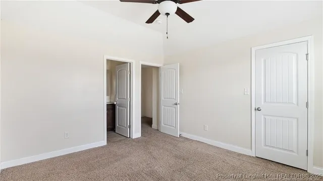a view of empty room with ceiling fan