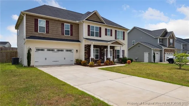 a front view of a house with a yard and garage
