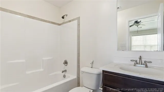 a bathroom with a bathtub a sink a toilet and a mirror