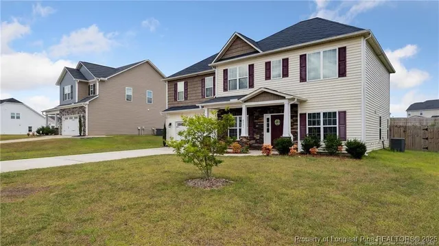 a front view of a house with a yard and porch