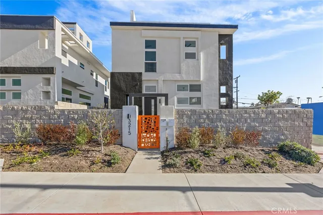 front view of a brick house with a yard