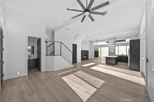 a bathroom with a granite countertop sink a toilet and a mirror