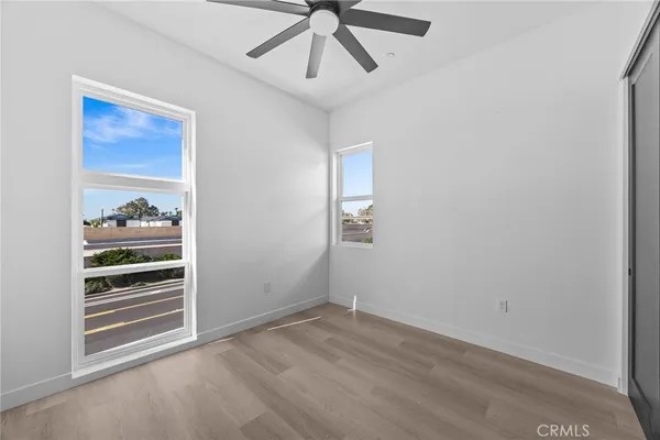 a bathroom with a granite countertop bathtub sink vanity mirror and toilet