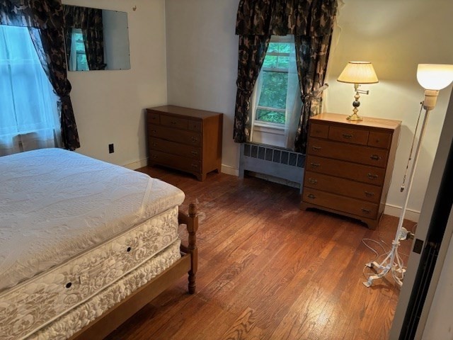 159 Florence Road Waltham, MA 02453 - Photo 7 of 12 a bedroom with a bed and a dresser