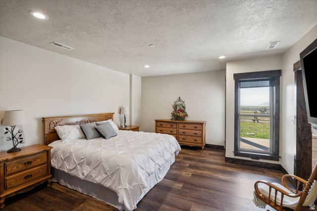6117 North Rocky Ridge Road Peoa, UT 84061 - Photo 64 of 82 Room with wood-finish flooring, recessed lighting, and a large window featuring dark wood trim