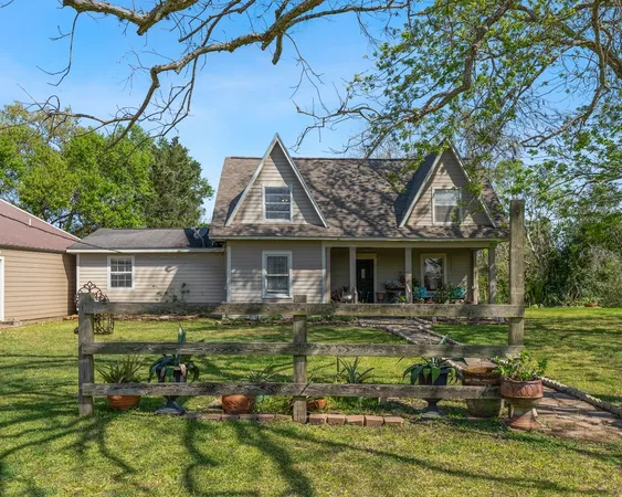 a front view of a house with a yard table and chairs