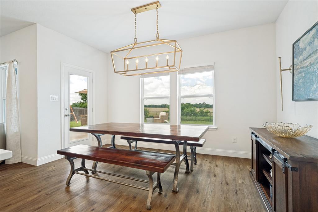 9424 Wildcat Ridge Godley, TX 76044 - Photo 11 of 25 a view of a dining room with furniture window and wooden floor