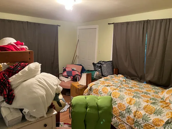 a bedroom with a bed and a window