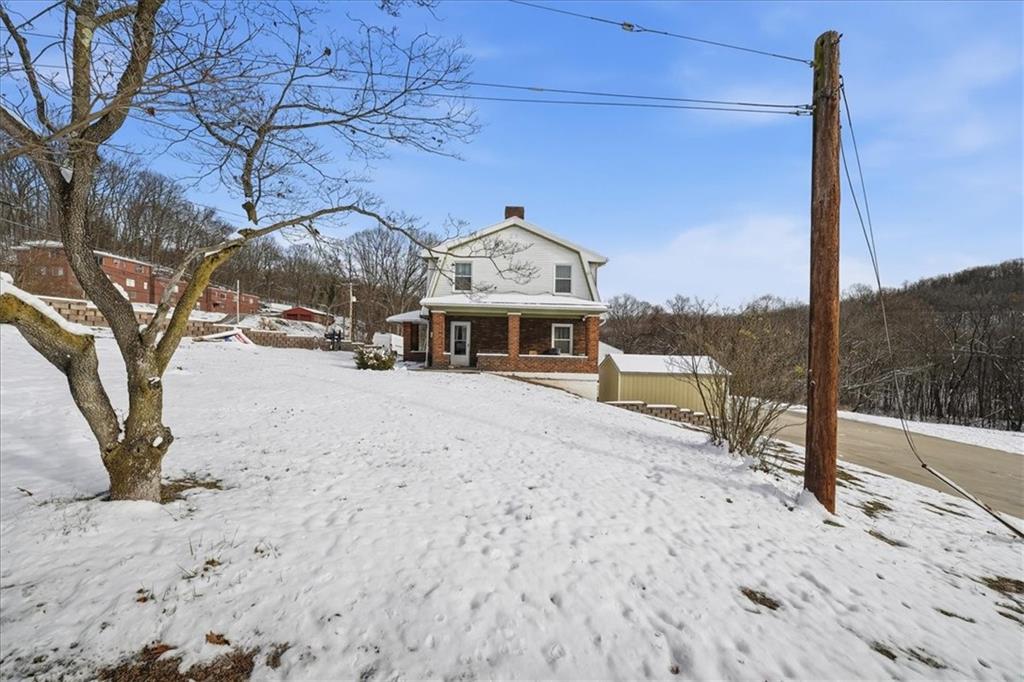 1060 Phillips Street Baden, PA 15005 - Photo 3 of 34 a view of a house with a snow in the yard