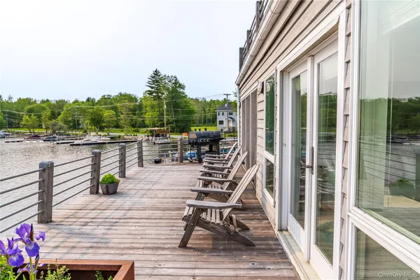 a view of balcony with seating space and trees in the background