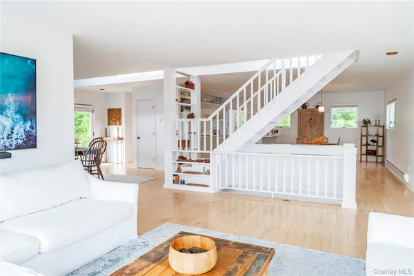 a living room with fireplace furniture and a wooden floor