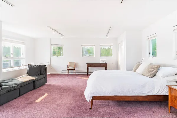a bedroom with furniture and windows