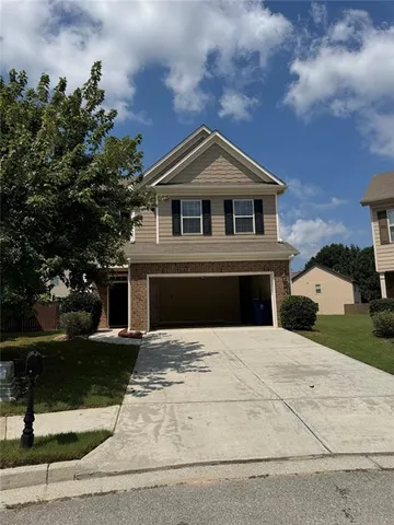 a front view of a house with yard