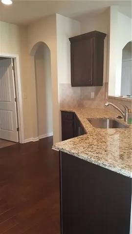 a kitchen with stainless steel appliances granite countertop a sink a stove and a microwave oven