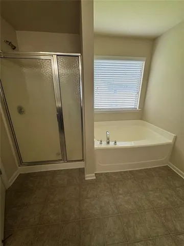 a bathroom with a tub and a shower