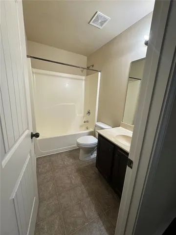 a bathroom with a sink a toilet a mirror and shower