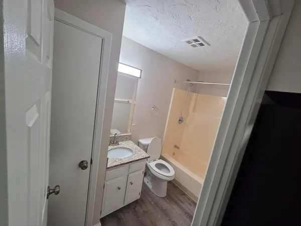 a bathroom with a sink and mirror with toilet