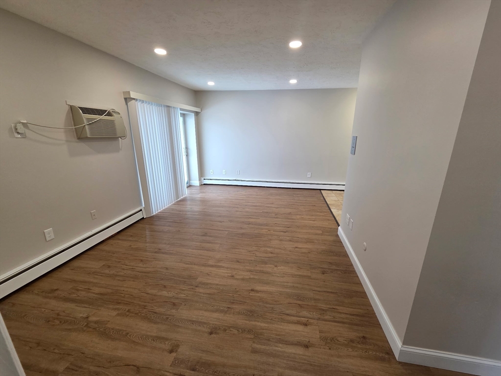 25 Ekman Street, Unit 13E Worcester, MA 01607 - Photo 7 of 10 a view of a hallway with wooden floor