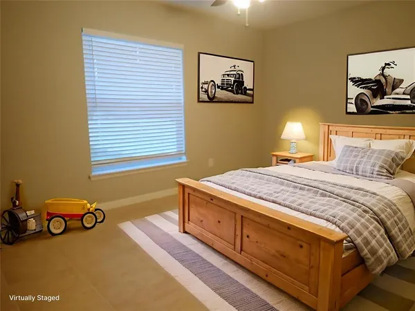 a bedroom with a bed and paintings on the wall