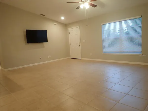 a view of empty room with ceiling fan