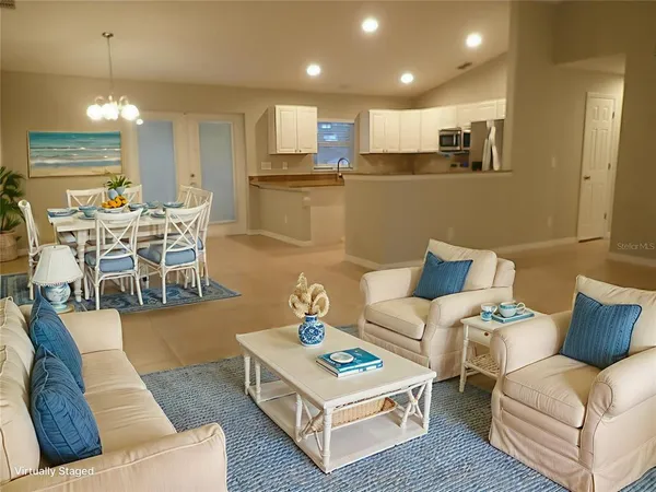a living room with furniture and kitchen view