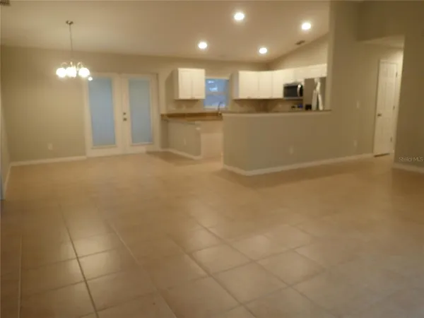 a view of a kitchen with a sink and refrigerator