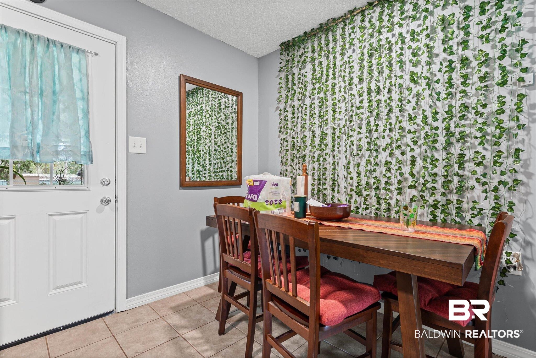14165 River Oaks Road, Unit A & B Coden, AL 36523 - Photo 15 of 35 Dining space featuring light tile patterned flooring and a textured ceiling