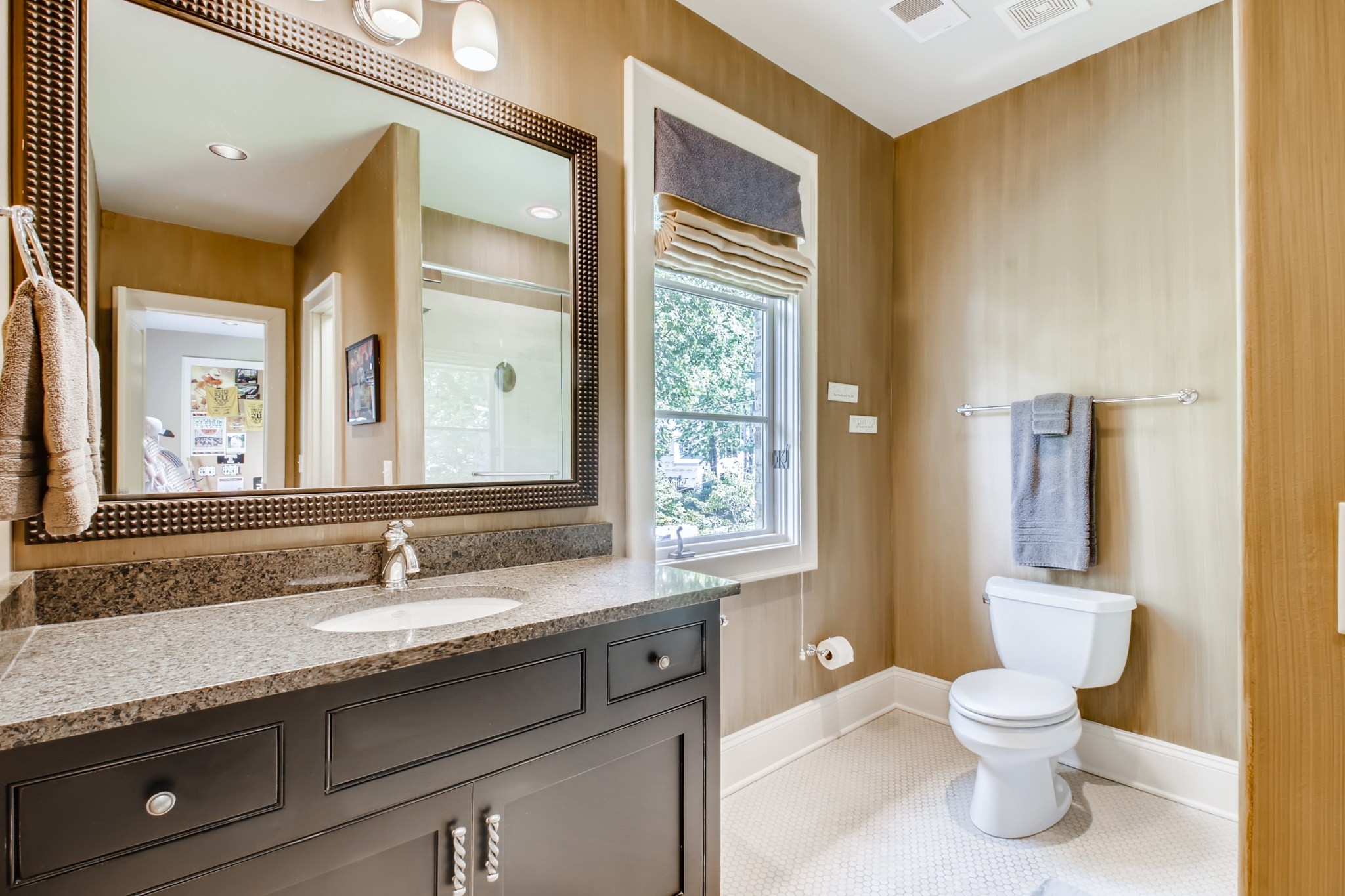 3919 Dorcas Drive Nashville, TN 37215 - Photo 29 of 40 a bathroom with a granite countertop sink toilet and mirror