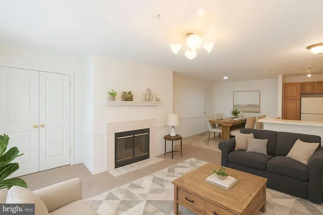a living room with furniture a fireplace and a chandelier