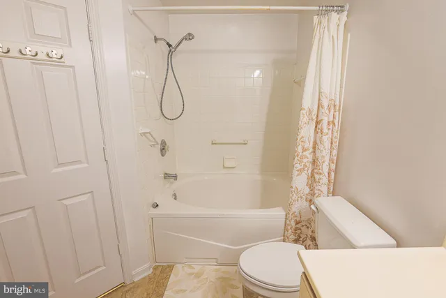 a bedroom with a bed a couch and a large window