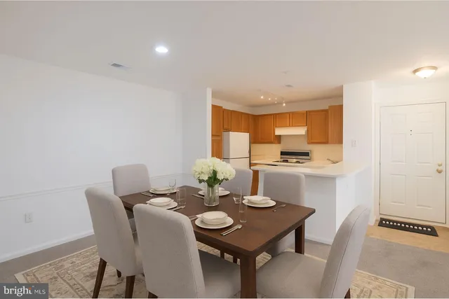a kitchen with stainless steel appliances a sink and a refrigerator